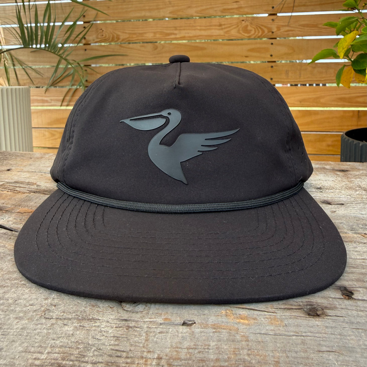 Salt SQD Coastal Reserve Cap in Midnight Zone, front view showing pelican patch logo and rope brim, displayed on a neutral background highlighting the cap's perforated panels and structured crown.