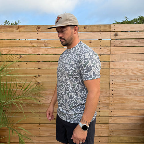 SaltWorn tee by Salt SQD in Marsh Camo with stretch fabric and a vintage-washed texture, shown outdoors.