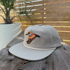 Salt SQD Coastal Icons cap in Brown Pelican with an adjustable snapback closure and perforated side panels.