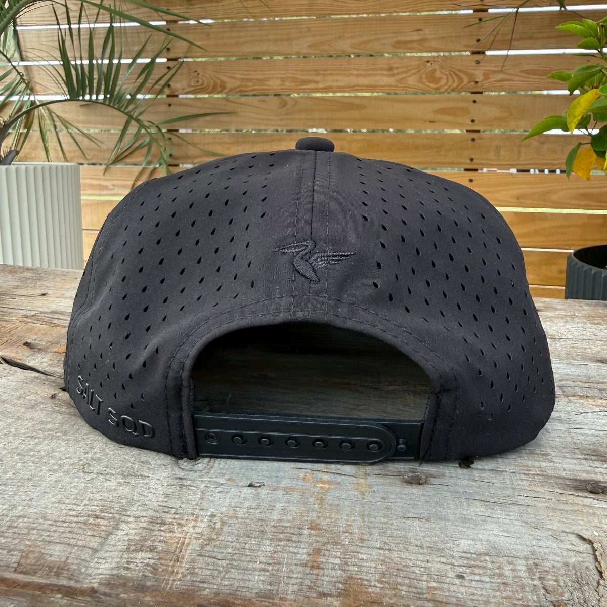 Salt SQD Coastal Reserve Cap in Midnight Zone, rear view showing perforated panels, snapback closure, and Salt SQD branding