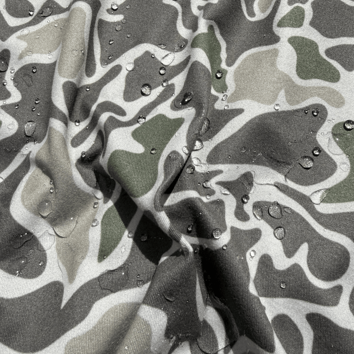 Youth Salt SQD SqdDrift fishing hoodie in Marsh Camo with a water-resistant finish for beach outdoor wear.