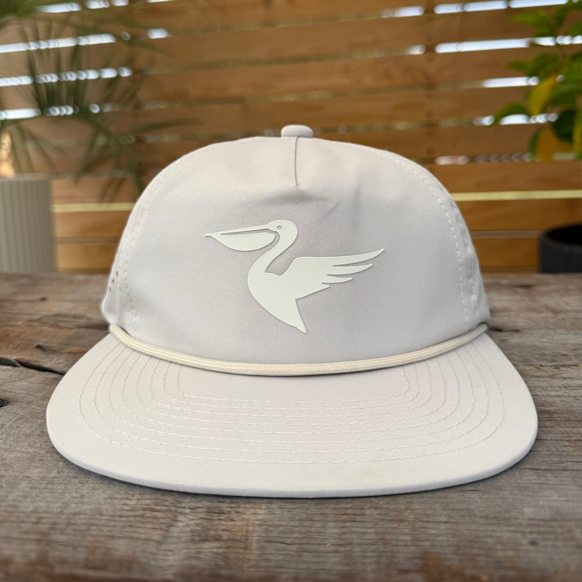 Salt SQD Coastal Reserve Cap in Bonefish, front view showing pelican logo and rope brim